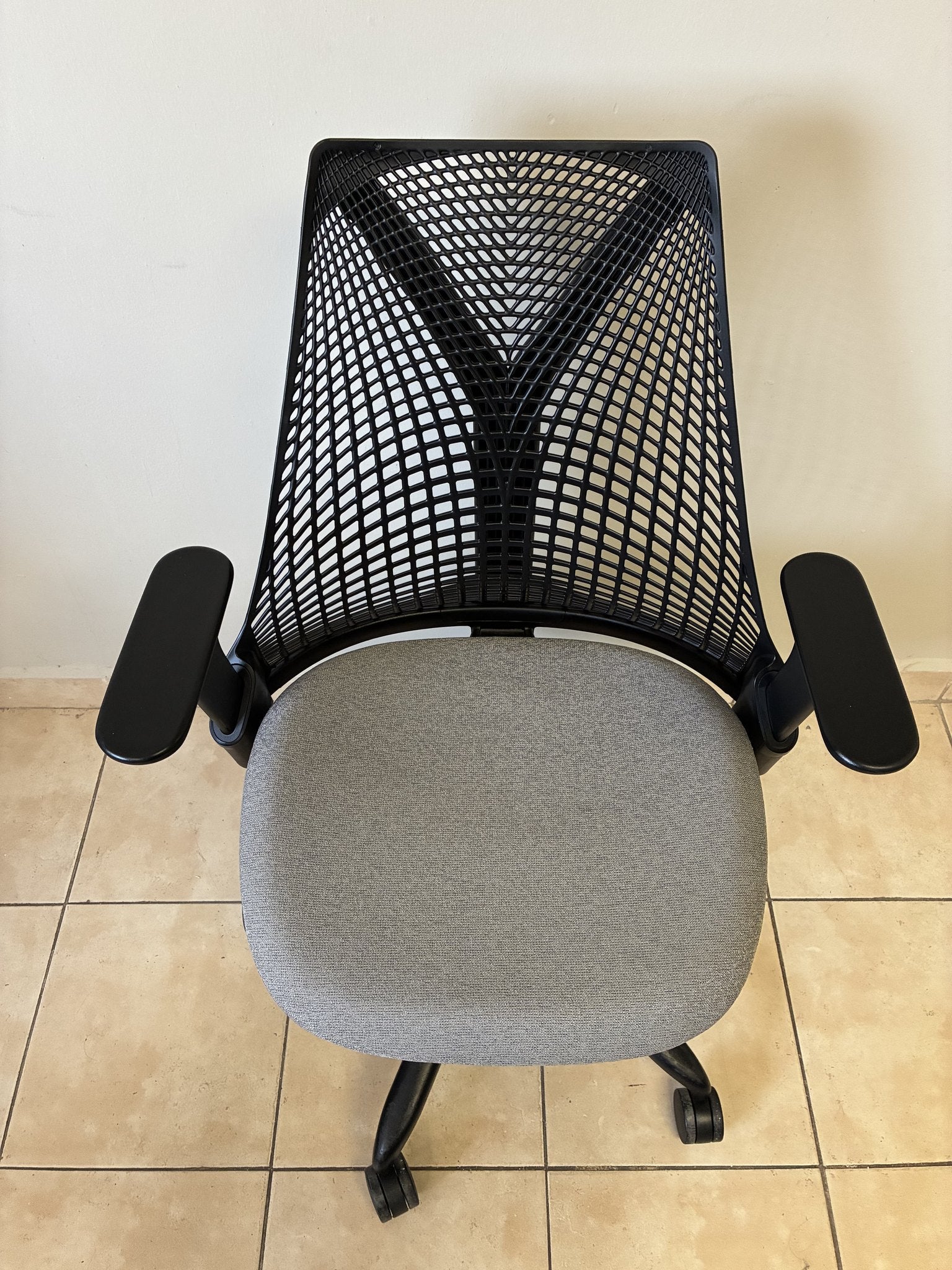 Silla de oficina Herman Miller Sayl pre-owned, con respaldo negro y asiento gris, vista superior.